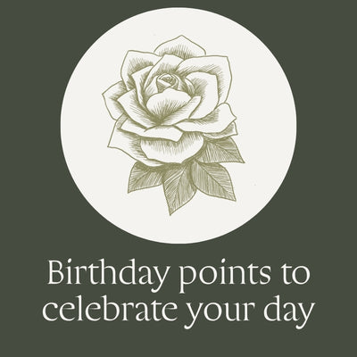 A square graphic with a dark olive green background, featuring a white circular badge with a detailed rose illustration in the center and the text 'Birthday points to celebrate your day' below in white serif font.