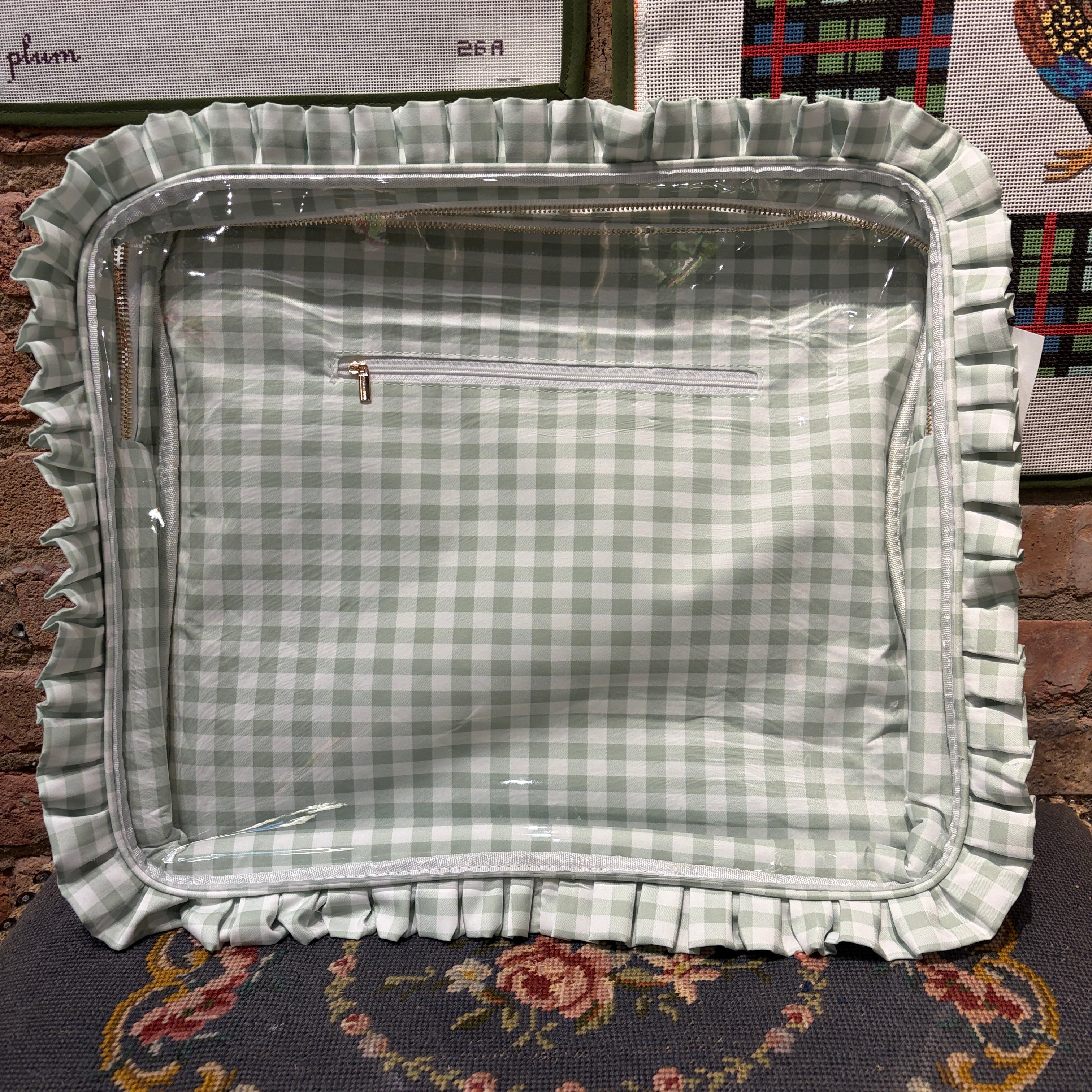 Green checkered fabric tray with ruffled edge on a patterned surface
