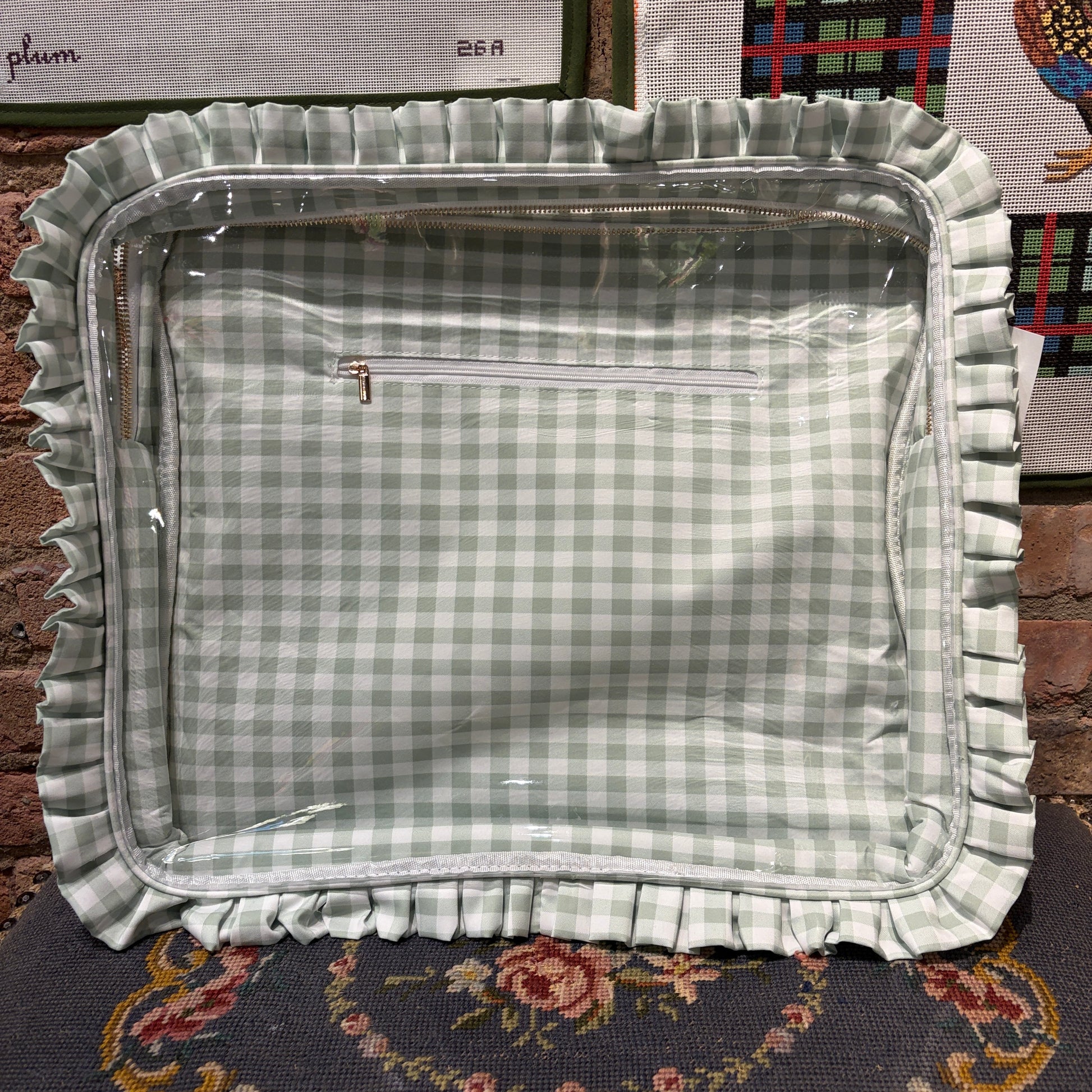 Green checkered fabric tray with ruffled edge on a patterned surface