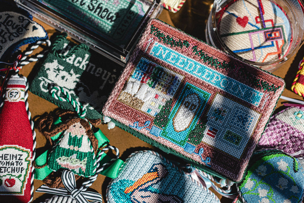 Collection of needlepoint items items including a house design and a ketchup bottle.  | The Pepper Pot Barrington, IL 