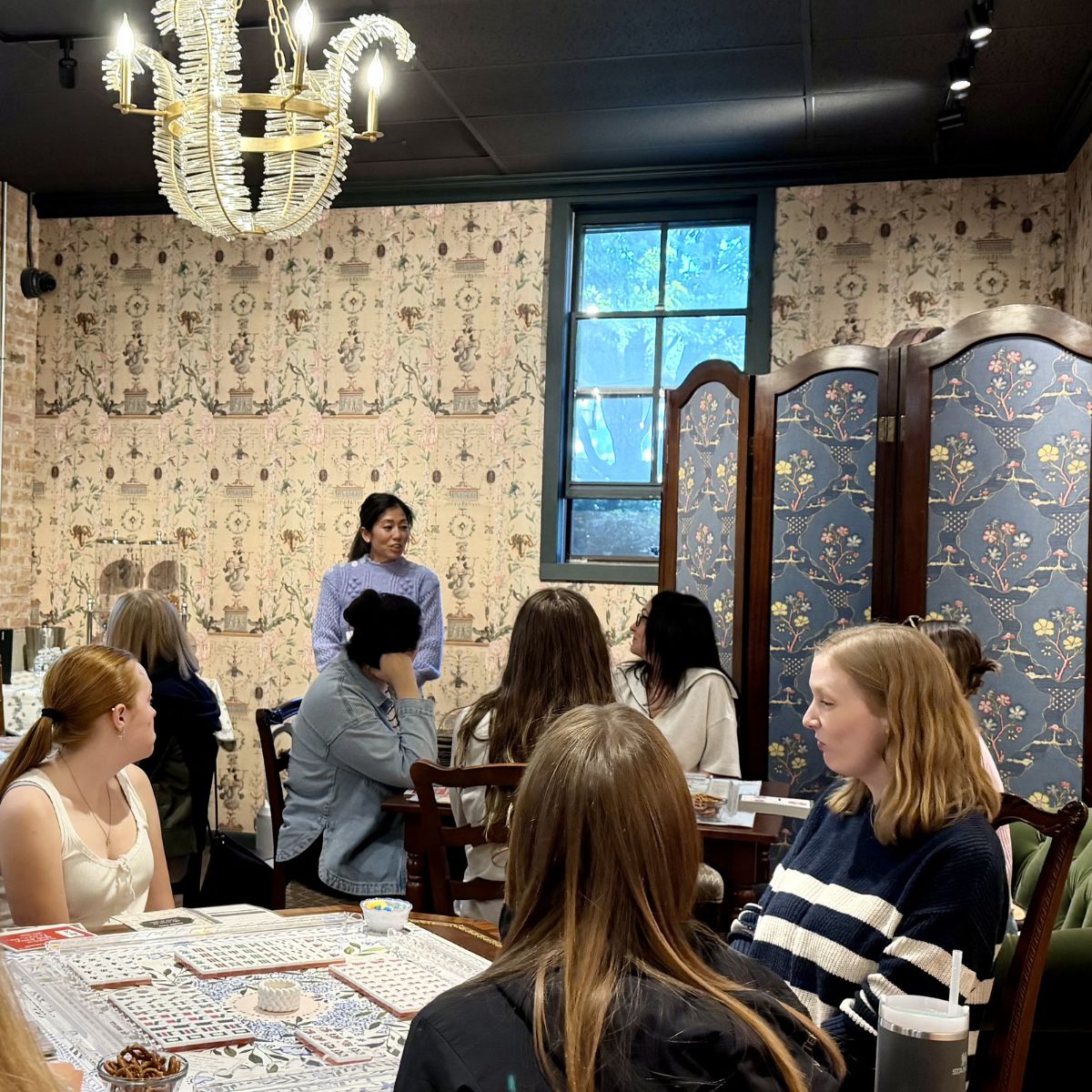 Group of people sitting at at tables learning American Mahjong at The Pepper Pot in Barrington, IL