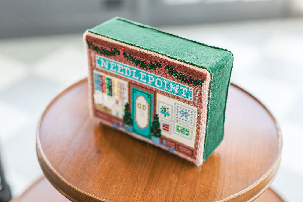 Small needlepoint box with a decorative design on a wooden surface. | The Pepper Pot, Barrington, IL