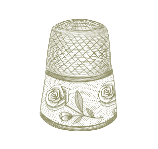 Decorative thimble with floral design on a white background
