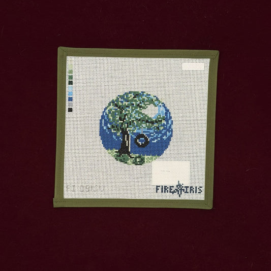 Needlepoint Canvas with a spring tree design on a dark background