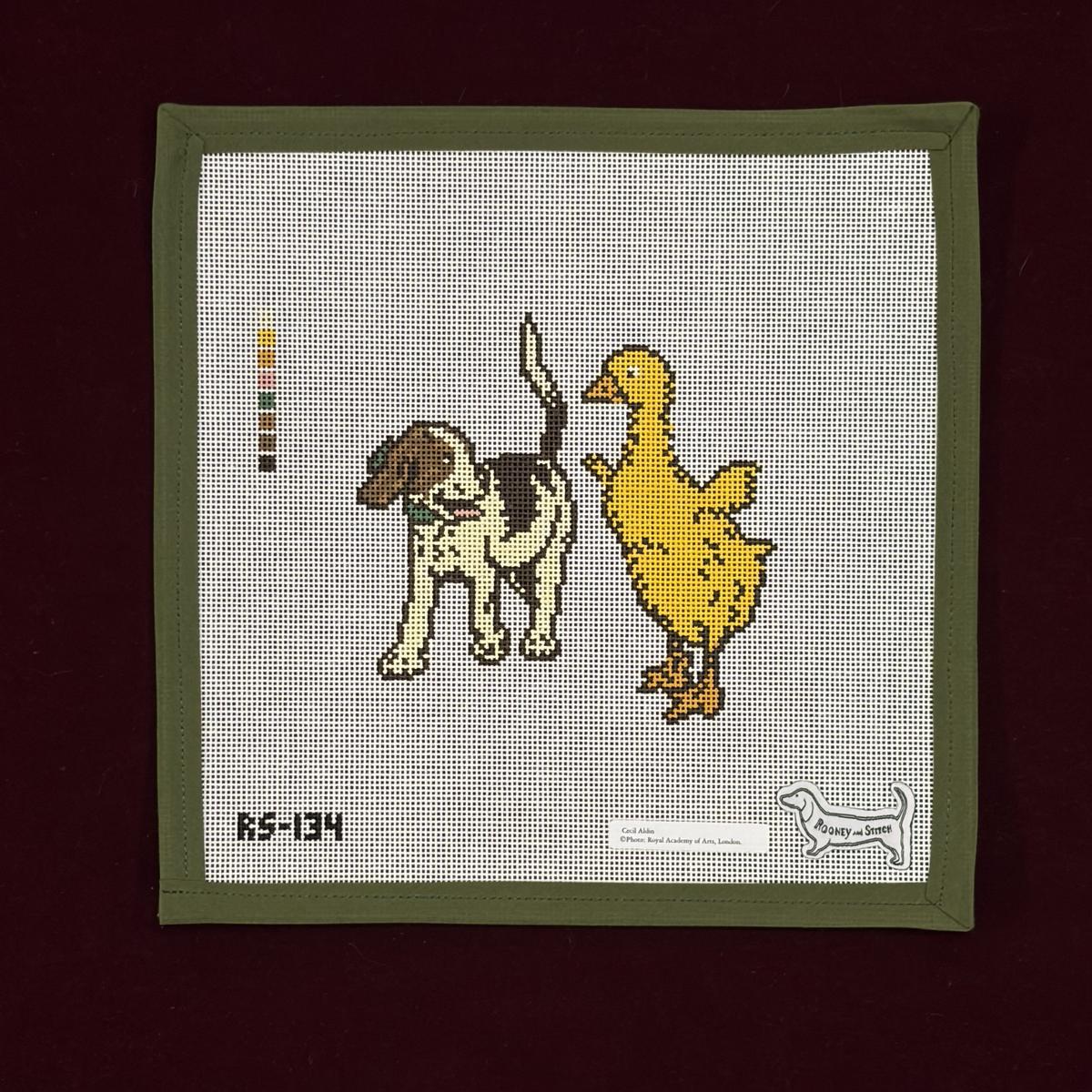 Needlepoint design of a dog and duck on with a green border.