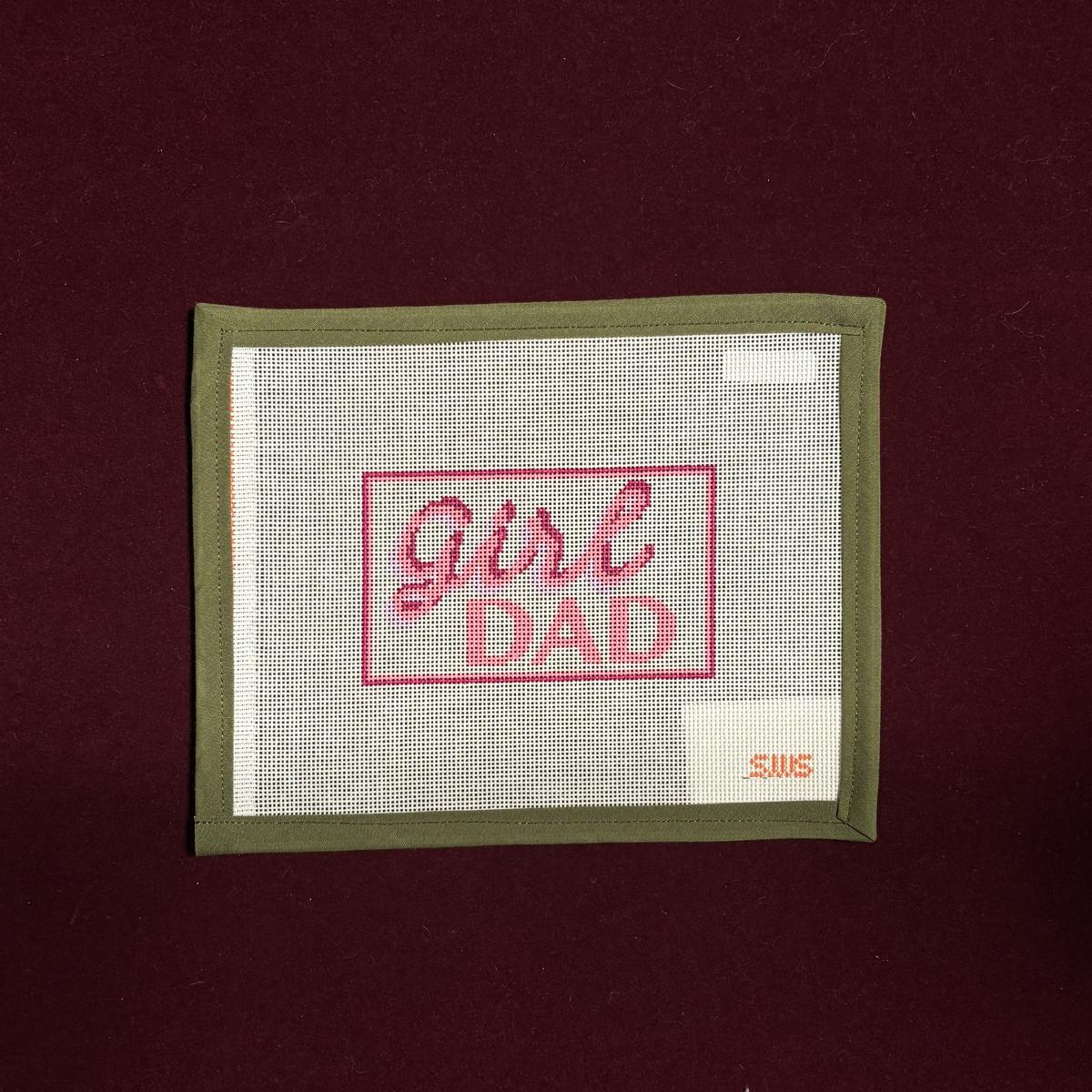 Needlepoint canvas design with 'Girl Dad' text in pink. 