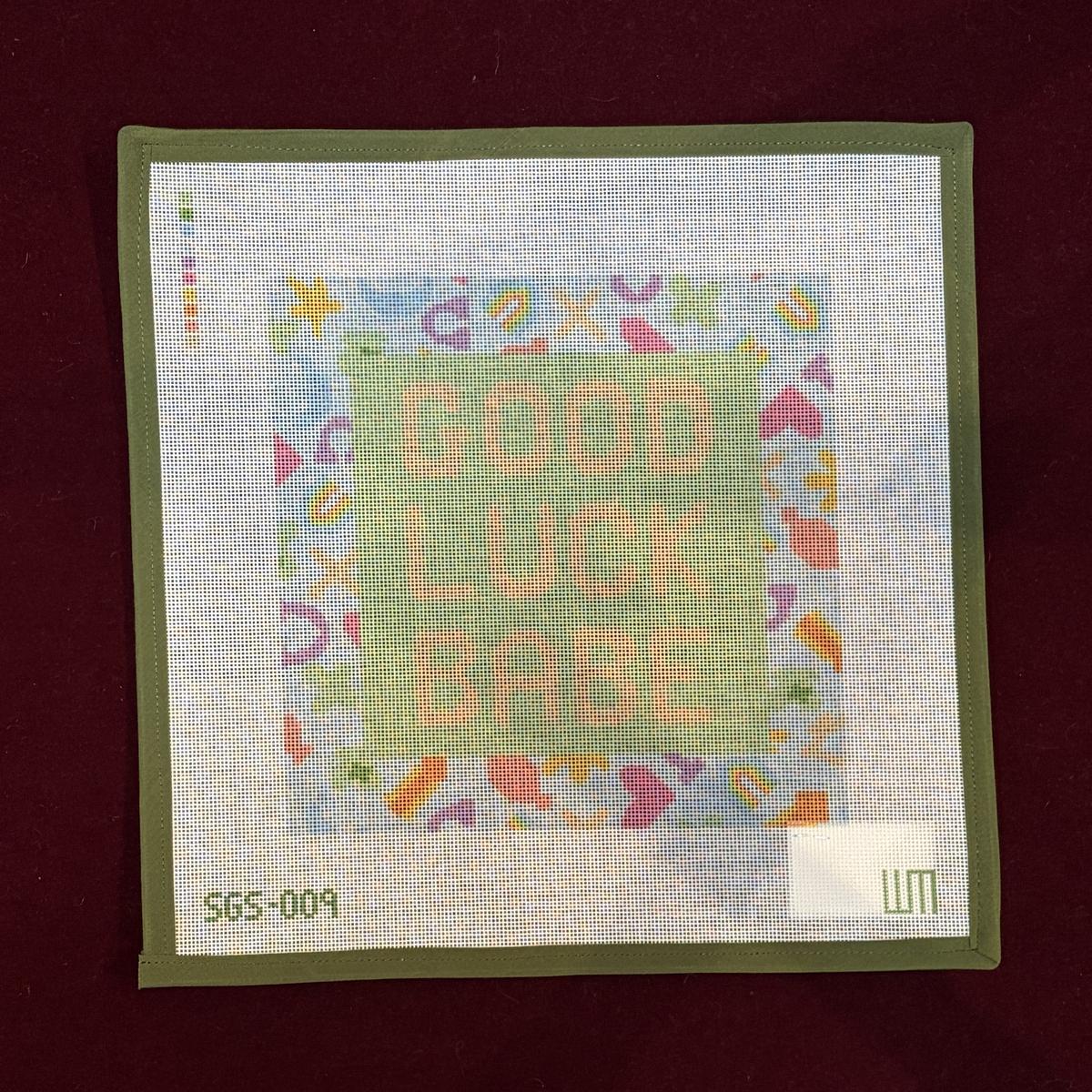 Needlepoint canvas design with 'Good Luck Babe' text on a fabric background
