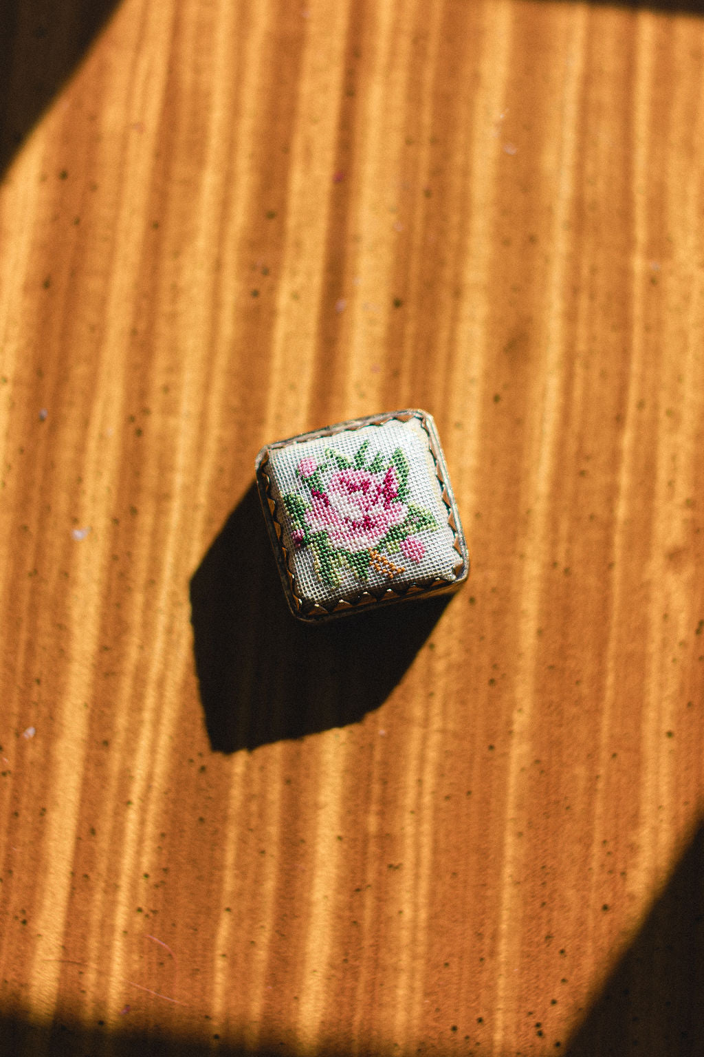 Small embroidered  hinged box with floral design on a wooden surface.  | The Pepper Pot Barrington, IL 