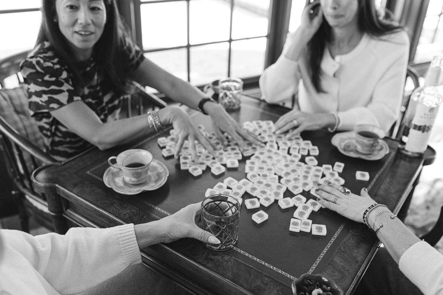 Women sitting around a table playing a game of mahjong at The Pepper Pot in Barrington, IL
