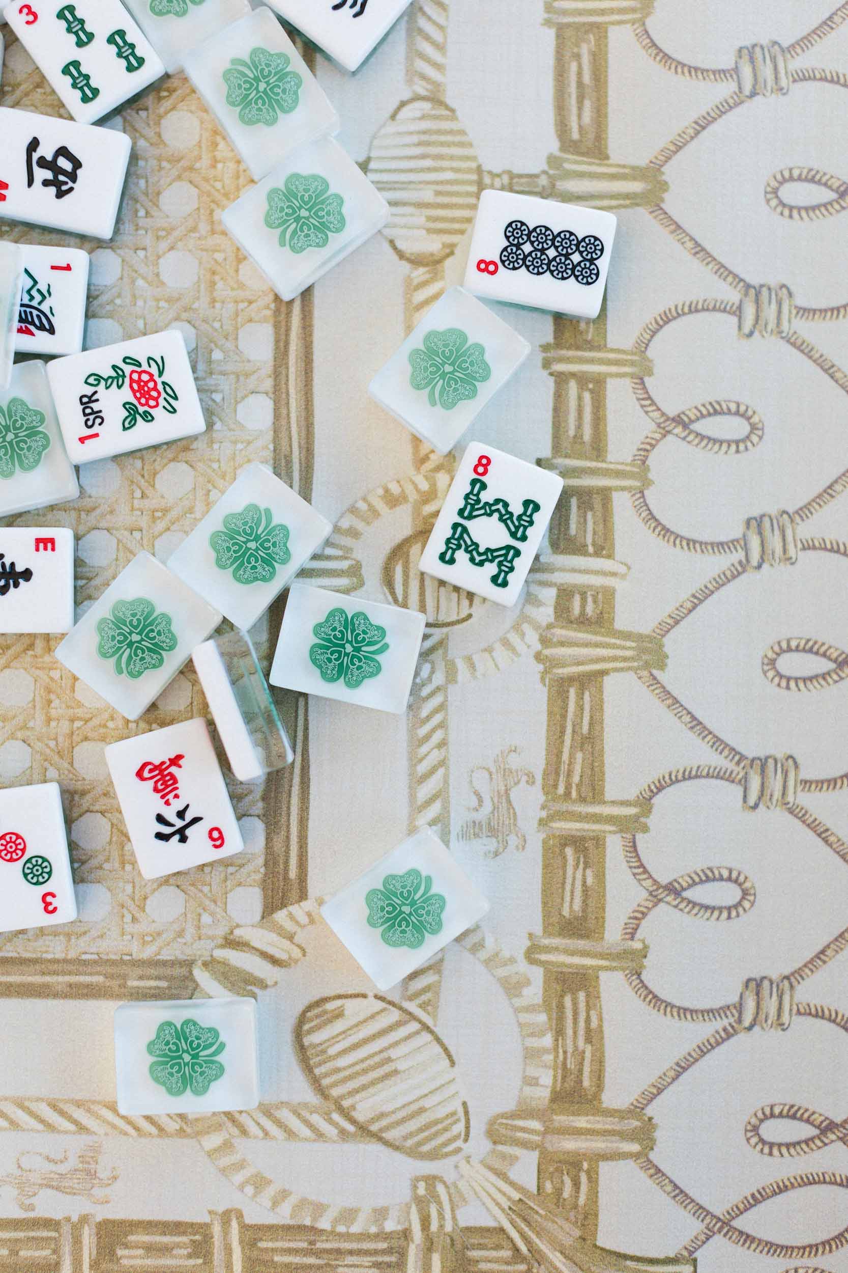 Mahjong tiles on a patterned surface. The Pepper Pot | Needlepoint and Mahjong Specialty Store in Barrington, IL