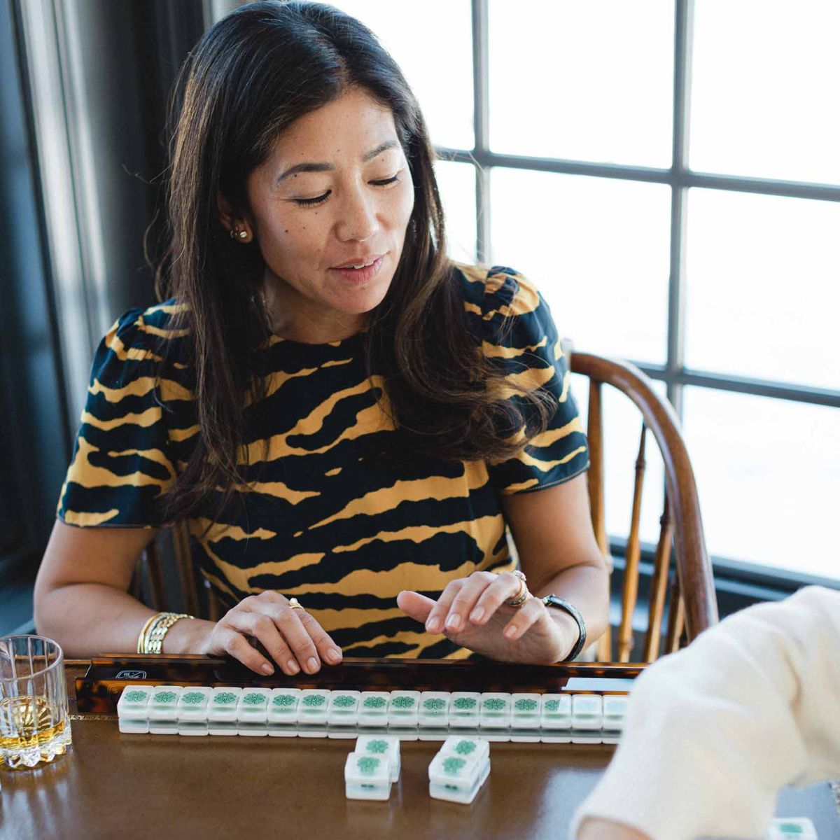 Crystal Pepper playing American Mahjong at The Pepper Pot in Barrington, IL with another person at a table.