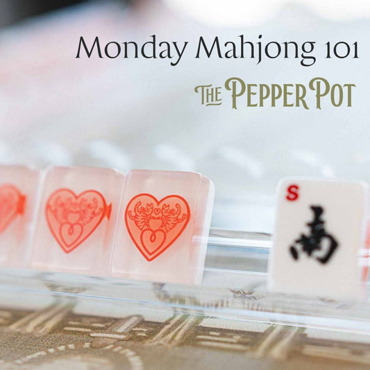 A close-up of several Mahjong tiles on a clear rack, with the text 'Monday Mahjong 101' and 'The Pepper Pot' overlaid at the top. The visible tiles include red heart symbols and a white tile with a black character.