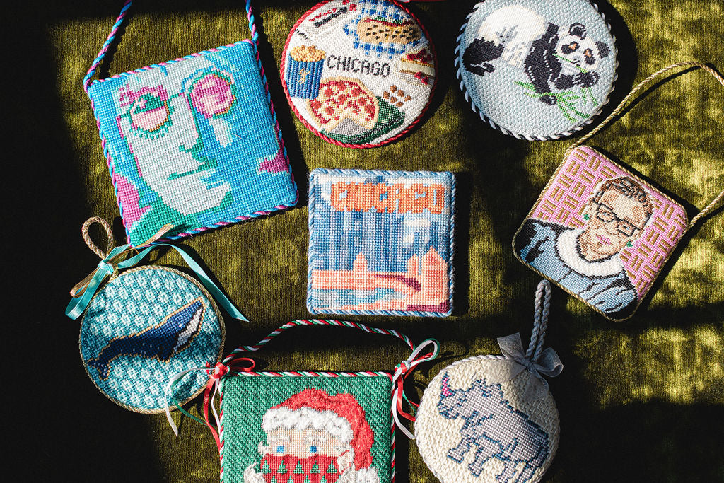 Collection of needlepoint ornaments on a textured surface.  | The Pepper Pot Barrington, IL 