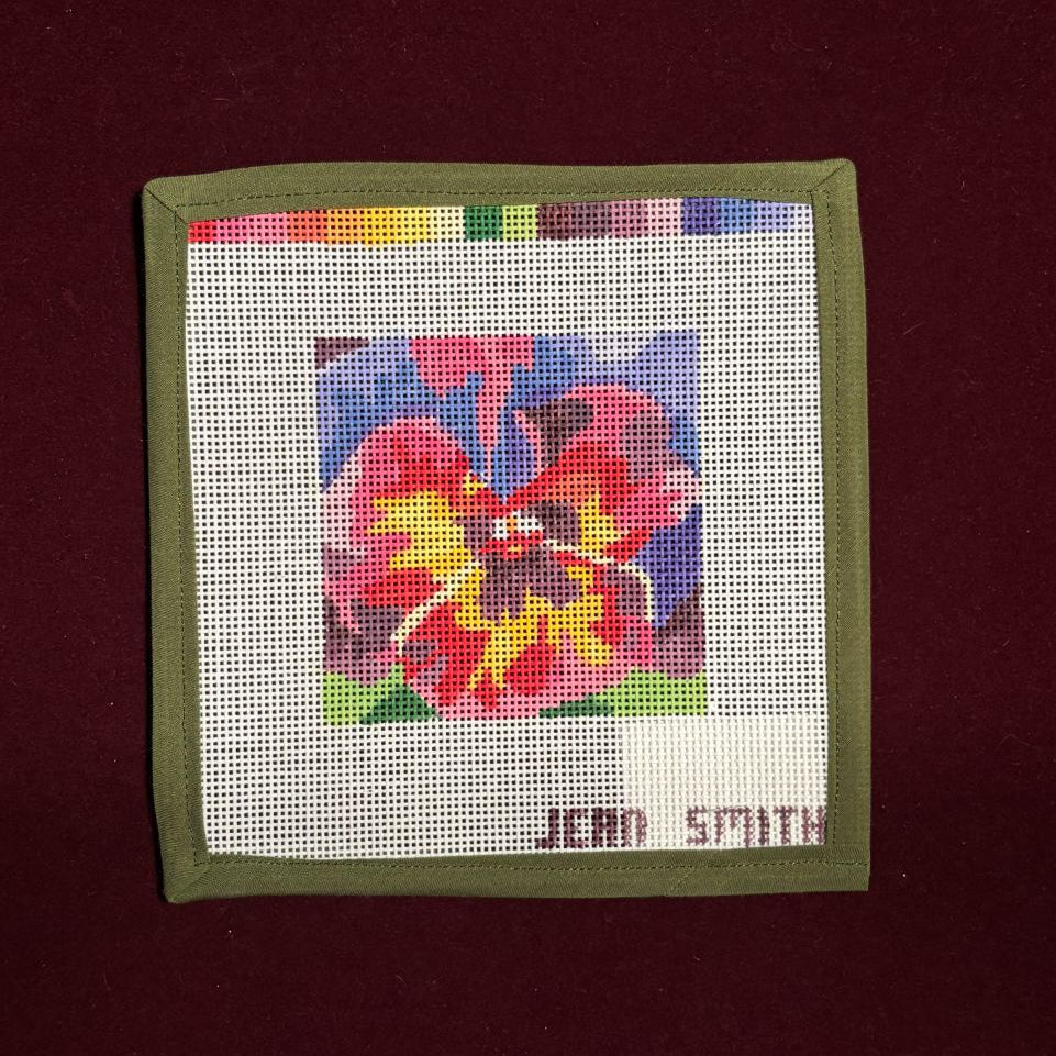 Colorful floral design needlepoint canvas with 'Jean Smith' branding on a maroon background
