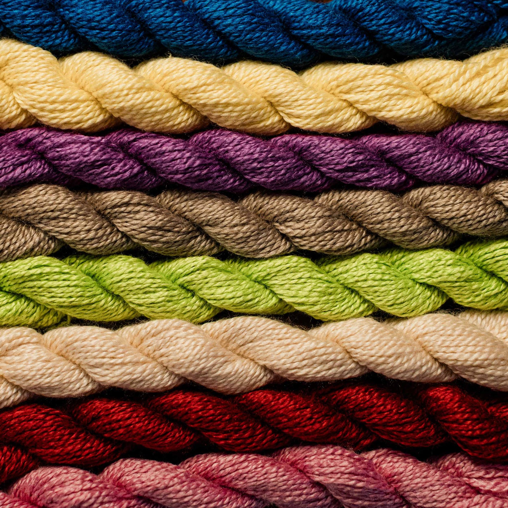 Stack of colorful yarn skeins in various shades. | The Pepper Pot, Barrington, IL