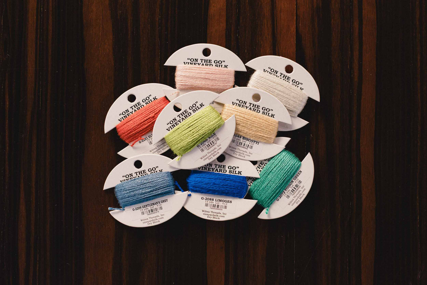 On the go vineyard silk threads. Set of colorful thread samples on a wooden background. | The Pepper Pot, Barrington, IL