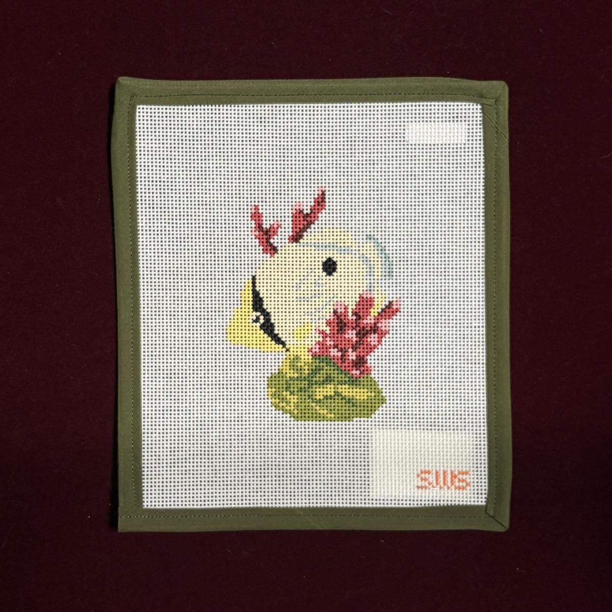 Needlepoint canvas design of a tropical yellow fish with red corral and a  green plant in the ocean. 